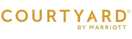 Courtyard by Marriott logo in gold lettering on a white background.